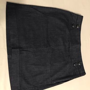 Navy above knee skirt. Button accents on waist.